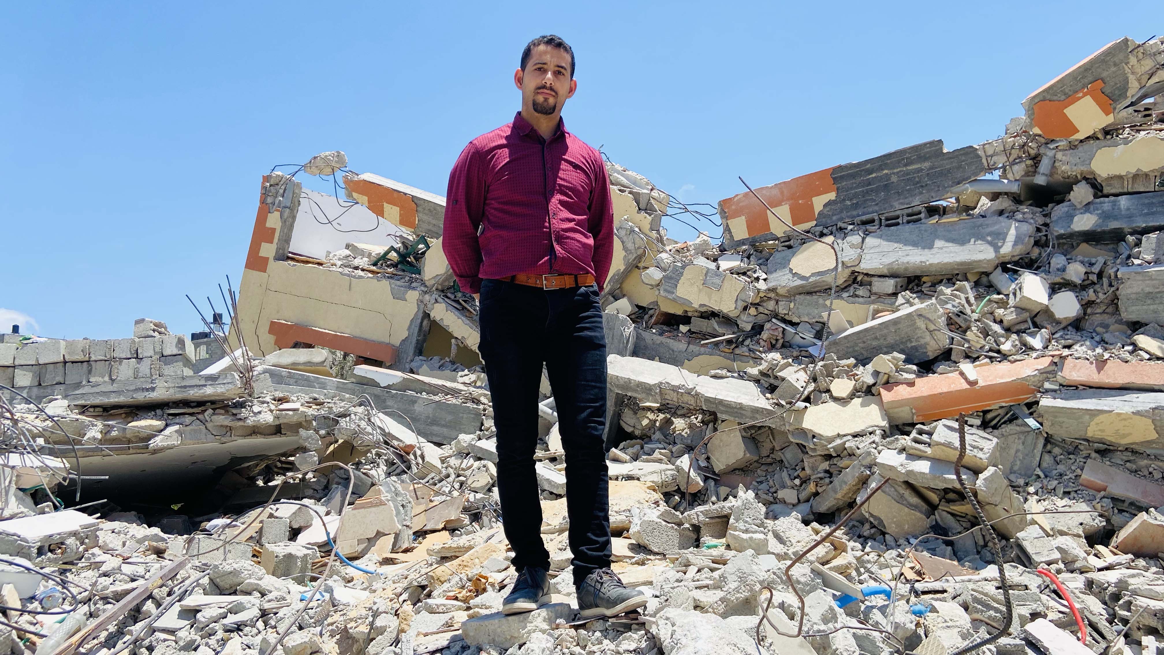 Mosab Abu Toha standing in ruins of Gaza